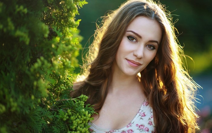 Portrait of Smiling Woman in Sunlit Nature