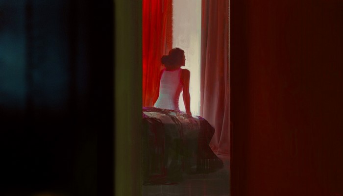 Woman in white dress by red curtains