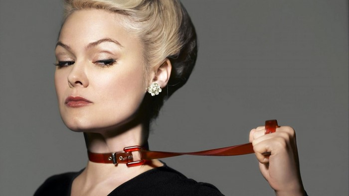 Woman wearing a red collar and holding a leash
