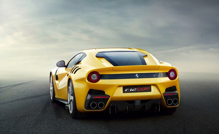 Yellow Ferrari F12 TDF parked on asphalt