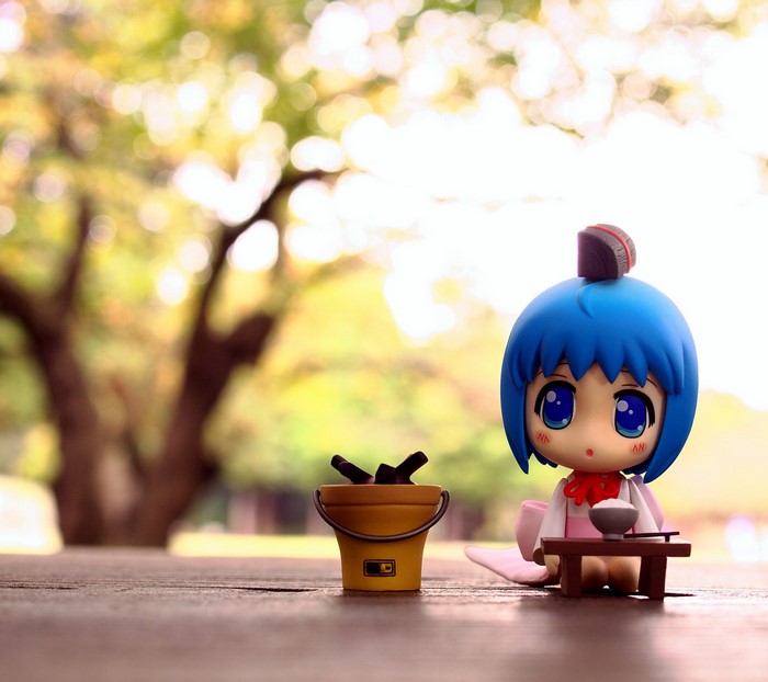 Anime figure with food and bucket in park