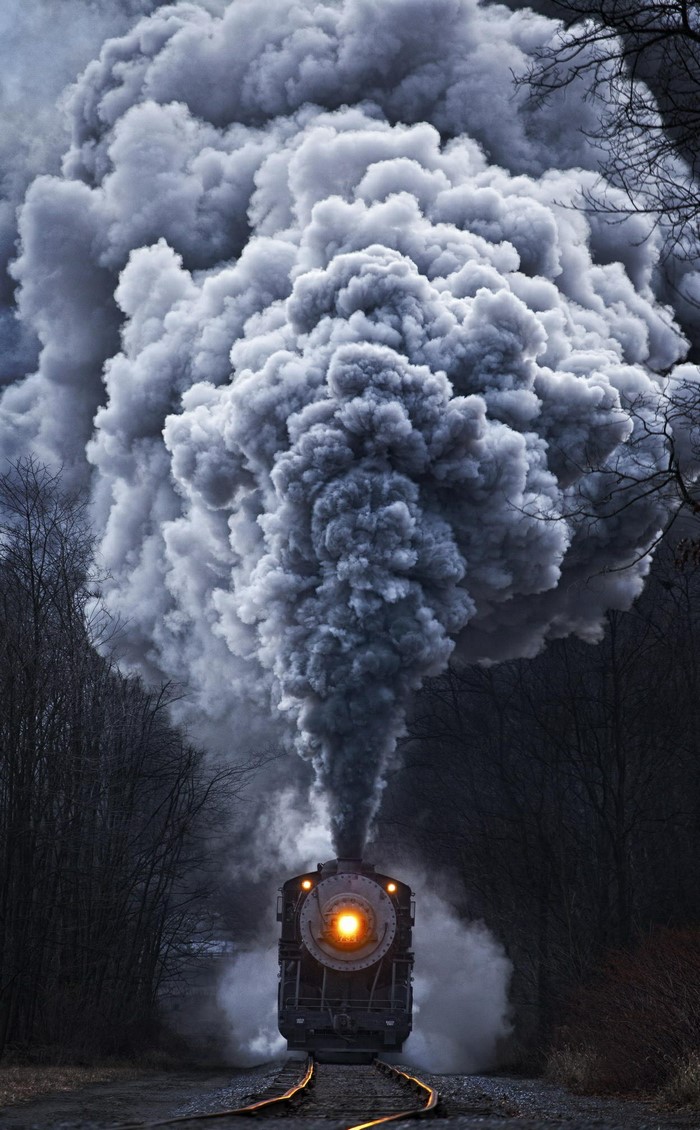 Steam train emitting large plume of smoke