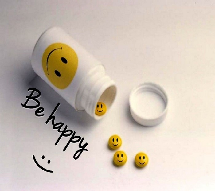 Pill bottle with smiley face pills and text