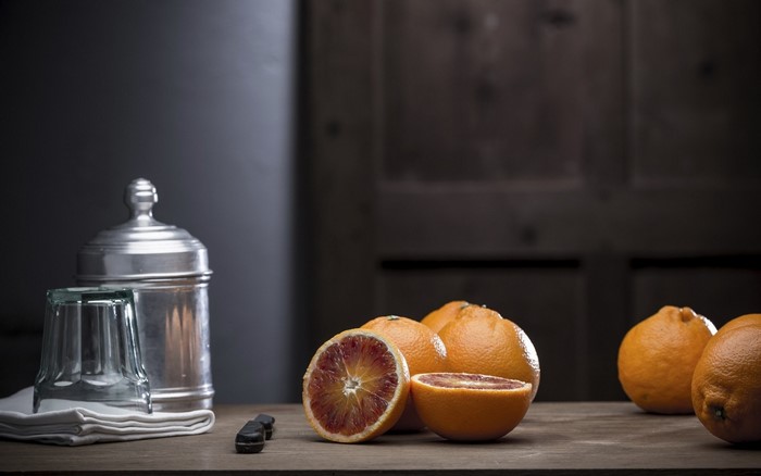 Still life of blood oranges and a glass jar