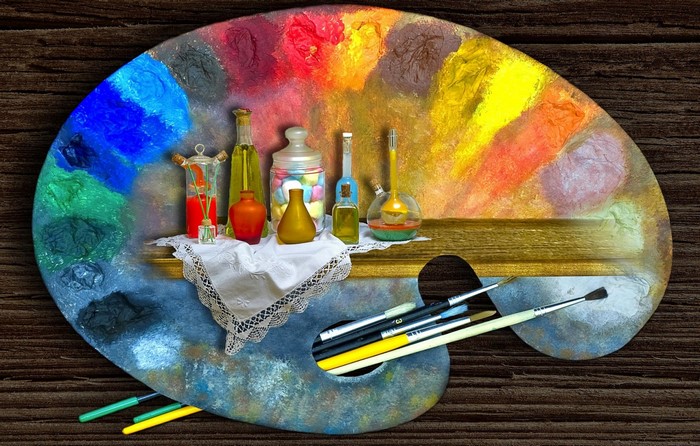 Art palette with paints, bottles, and brushes
