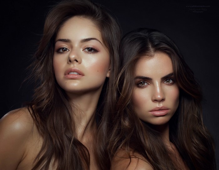 Two beautiful women with long brown hair posing