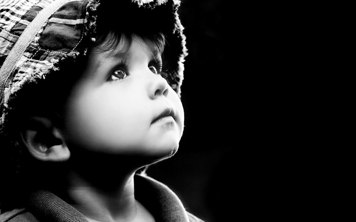 Black and white portrait of a child looking up