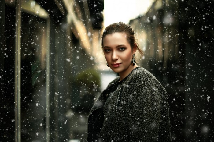 Woman in a fuzzy coat in the snow