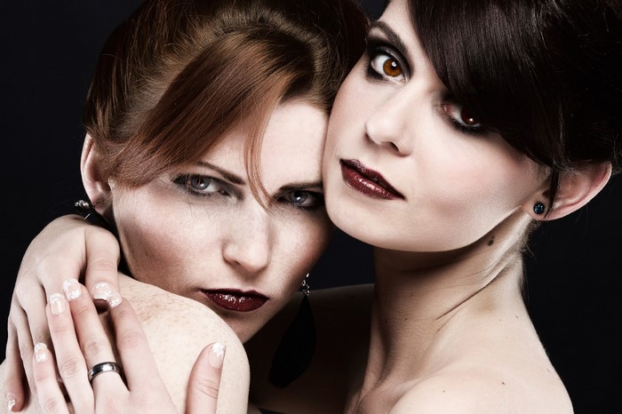 Two women with dramatic makeup and dark lipstick