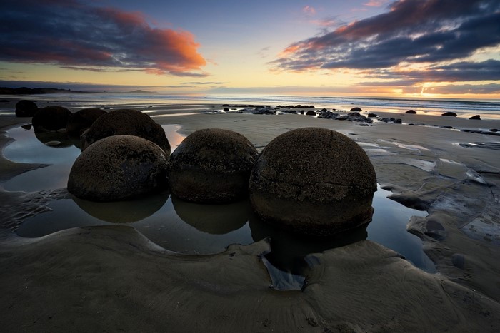 Moeraki Boulders at sunset on the beach