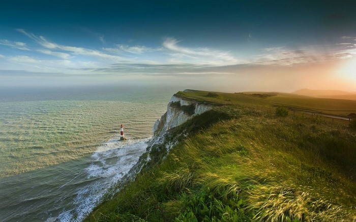Sunset Over Cliffside Lighthouse and Ocean Bay