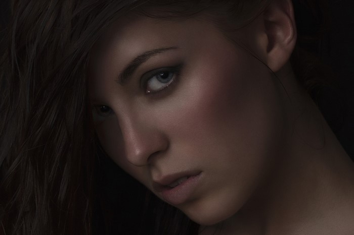 Portrait of a woman with dark hair and blue eyes