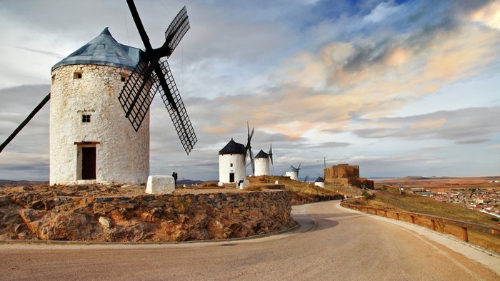 Windmills on a hill with a town in the background