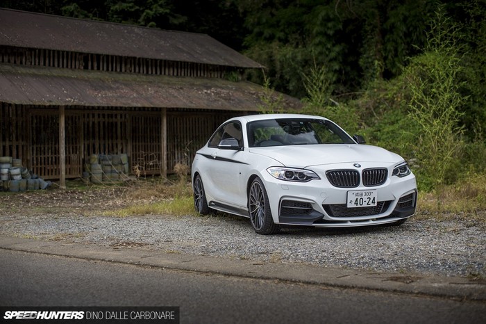 White BMW M235i Coupe parked near old building