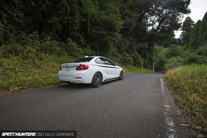White BMW M235i on a winding road