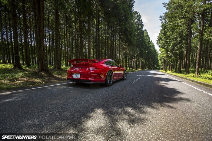 Red Porsche 911 GT3 on a Tree-Lined Road