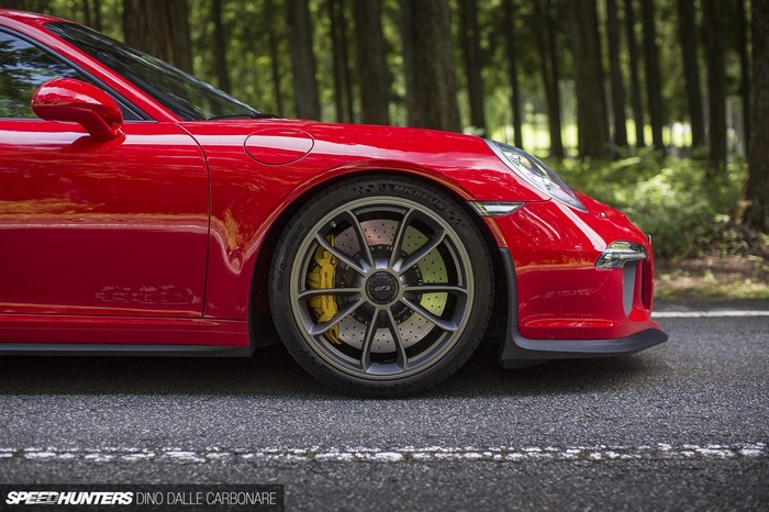Red Porsche 911 GT3 sports car on a road