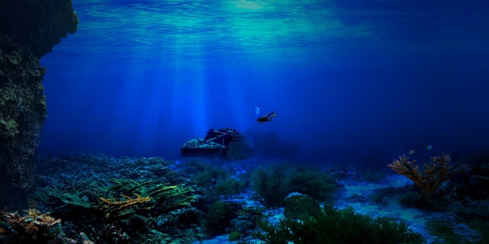 Underwater shipwreck with diver and coral reef