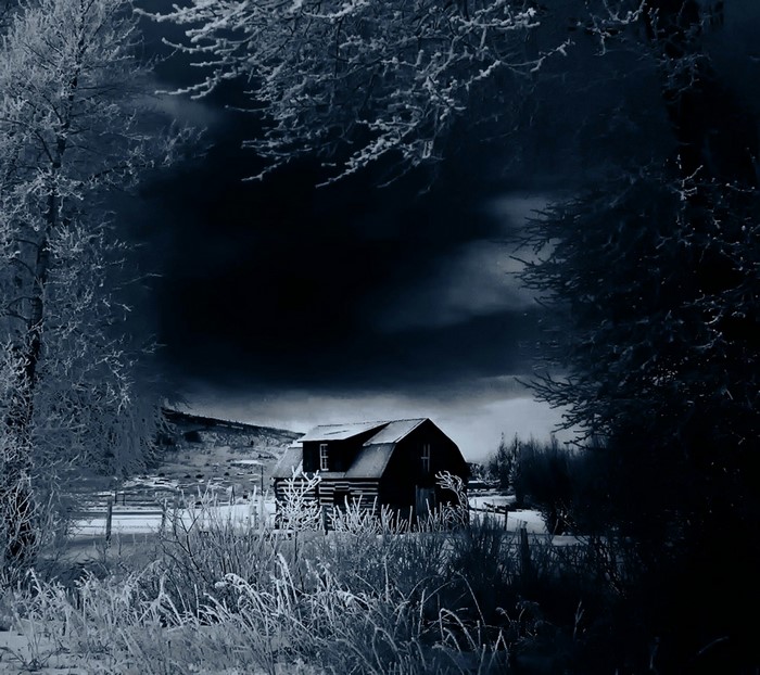 Barn in a snowy landscape at night