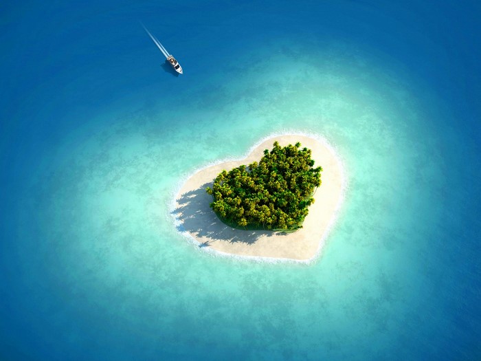 Heart-shaped island in the ocean with a boat