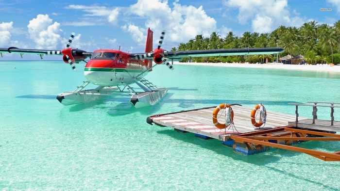 Seaplane docked at a tropical island pier