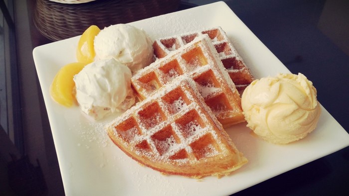 Waffles with ice cream and peaches
