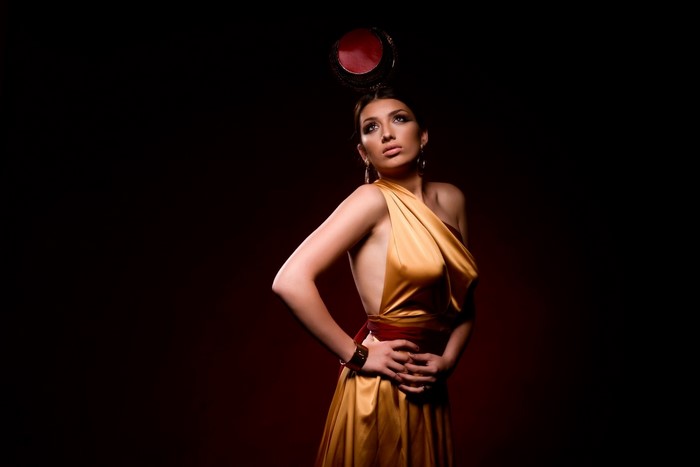 Woman in golden dress with headpiece