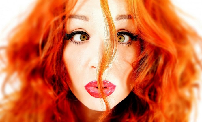 Close up portrait of a redhead woman with bright red lips