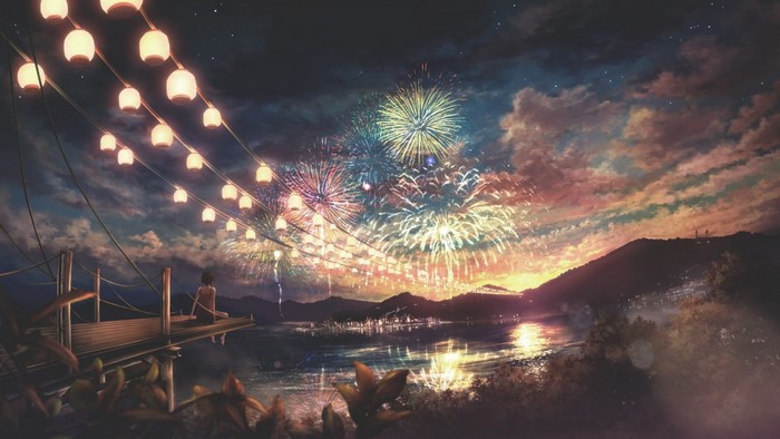 Fireworks display over a town at night with lanterns