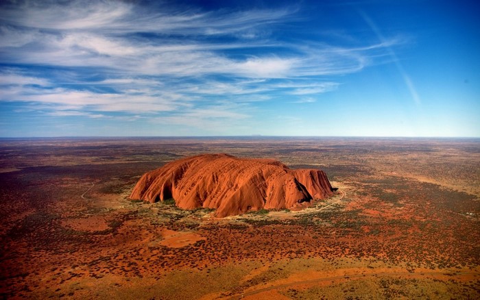 Uluru (Ayers Rock) in the Australian Outback under a blue sky