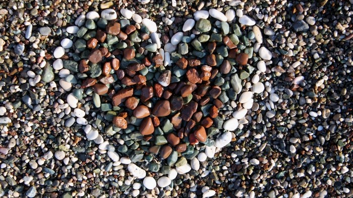 Heart shape made of pebbles on a beach