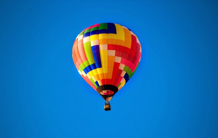 Colorful hot air balloon against a clear blue sky