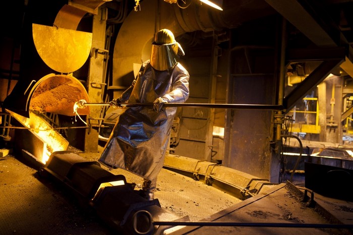 Worker in protective gear in an industrial setting