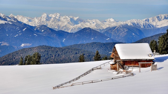 Wooden cabin in snowy Alps mountains