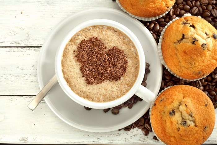 Coffee with heart-shaped chocolate and muffins