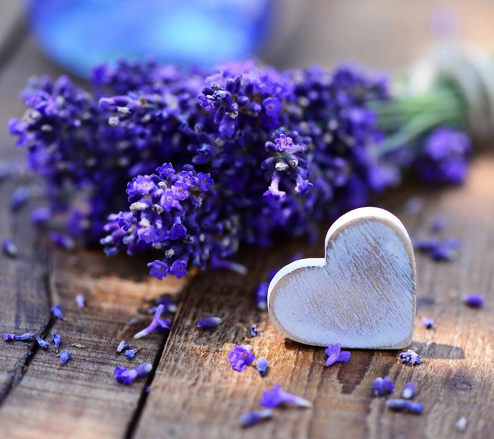 Lavender flowers and a wooden heart on a table