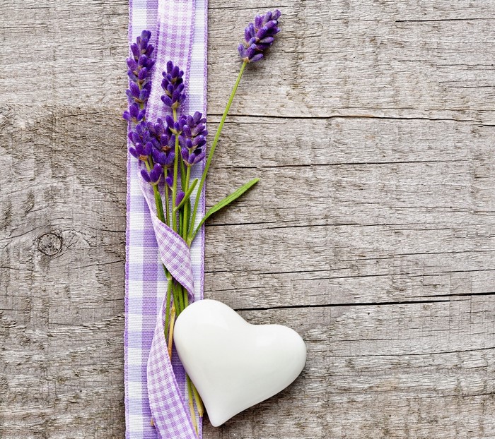 Lavender flowers and heart on wooden surface
