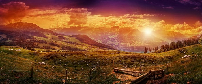 Panoramic mountain valley at sunset with dramatic clouds