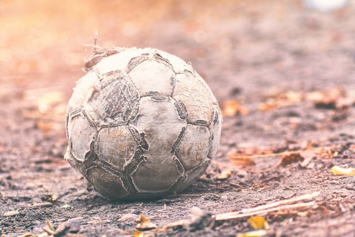 A worn soccer ball on the ground