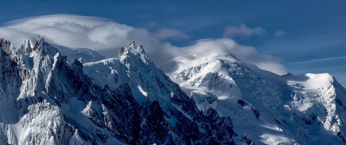 Snow-covered mountains with lenticular clouds