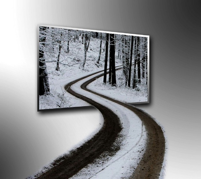 Snowy forest road emerging from a picture frame