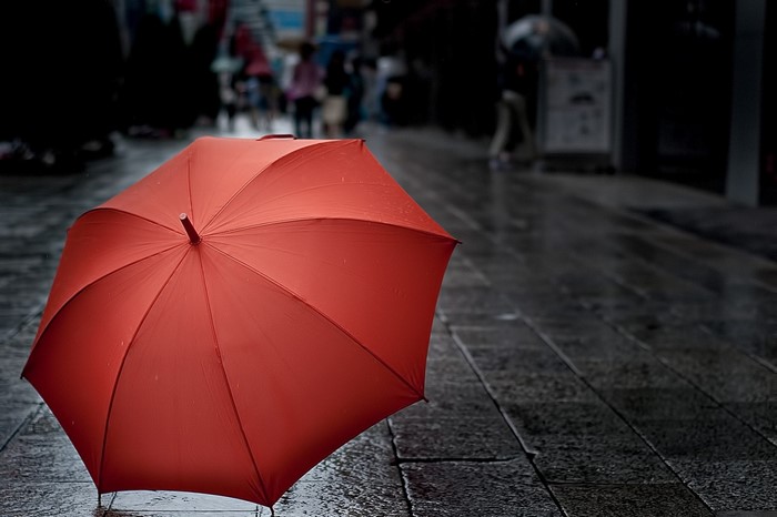Red umbrella on a wet street