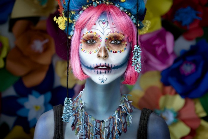Woman with Day of the Dead makeup and colorful headdress