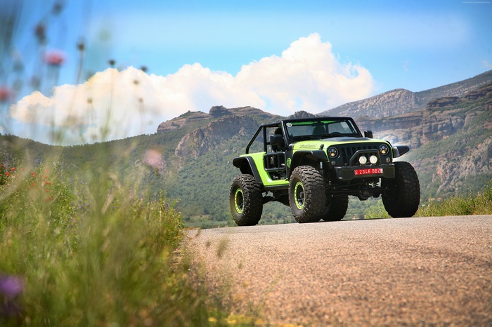 Green Jeep Trailcat SUV on a Mountain Road