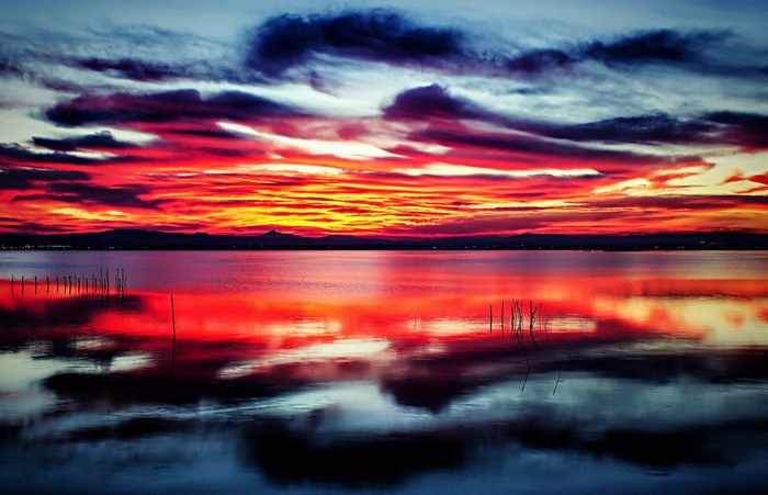 Sunset over a calm lake with colorful clouds and reflections