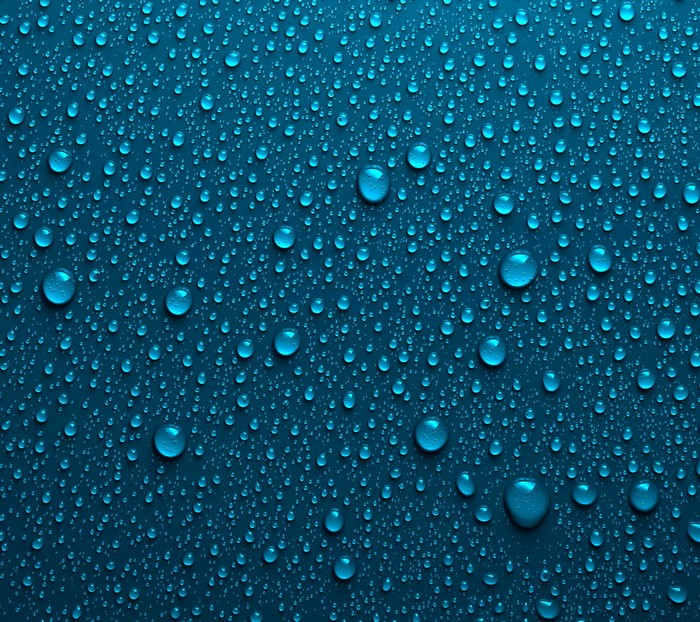 Blue water drops on a dark blue surface