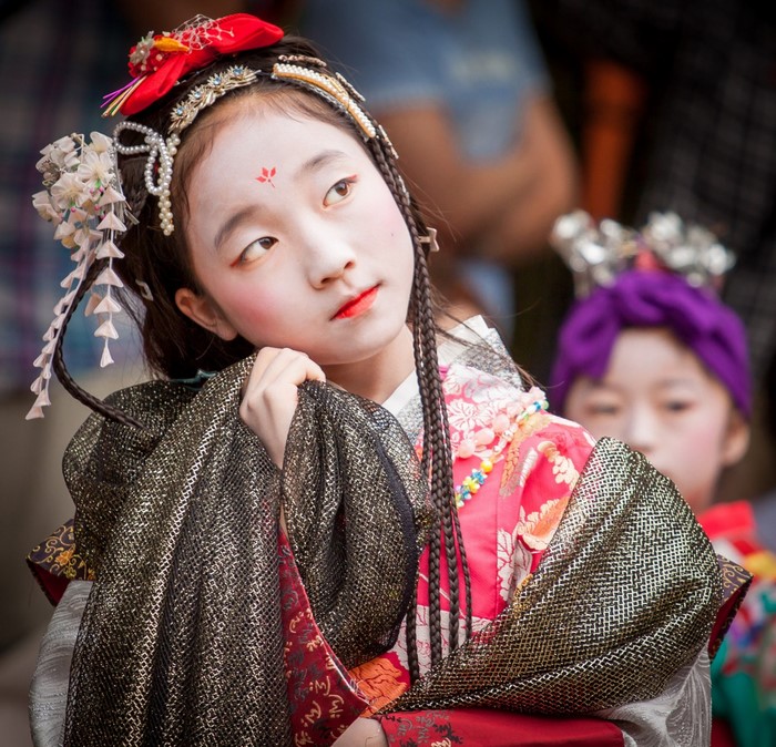 Young girl in traditional Japanese costume with face paint
