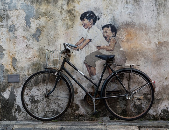 Children riding a bicycle mural in Pulau Pinang