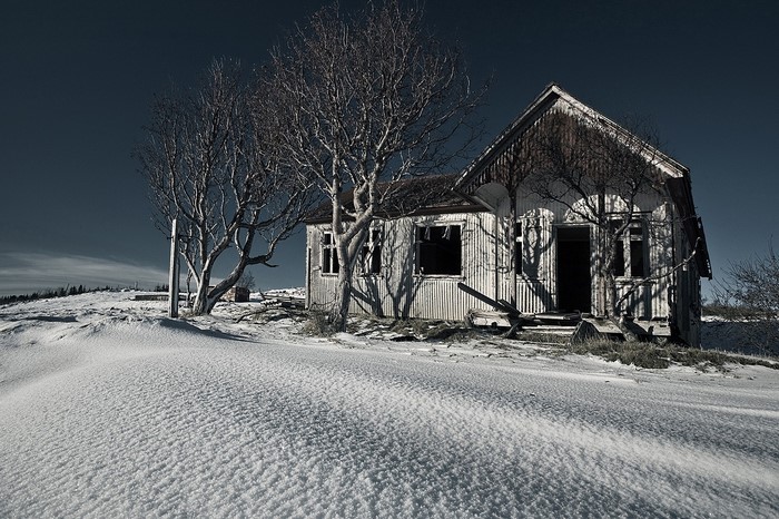 Abandoned house in a snowy landscape