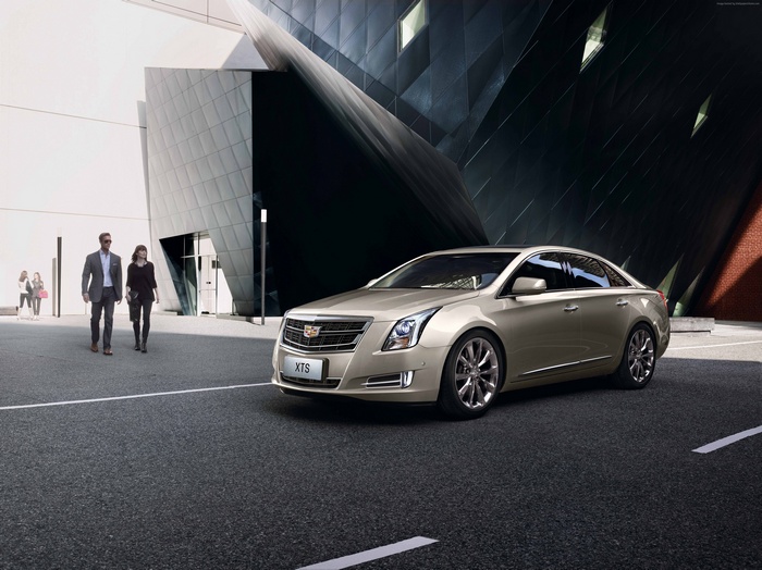Cadillac XTS sedan parked on asphalt road
